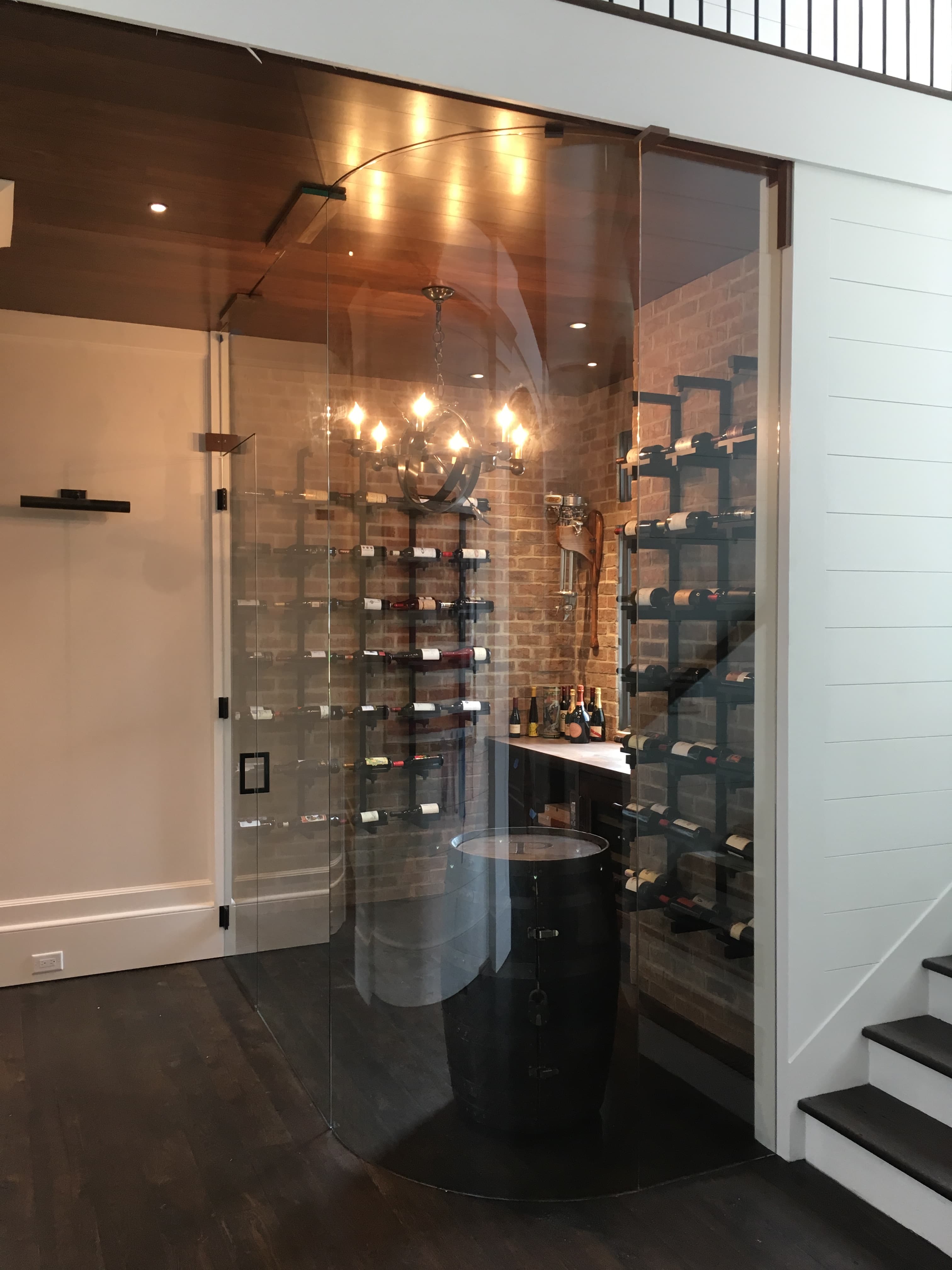Curved glass wine room crafted by Custom Glass Works of Fort Mill